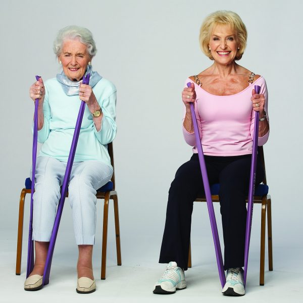 Rosemary Conley and her elderly Mother in Law seated, demonstrating an exercise with a toning band