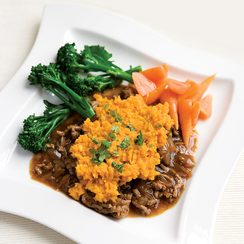 A plate of Cottage Pie with broccoli and carrots