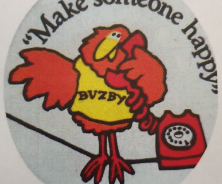 A 1980's button badge with the GPO Telephones character Buzby on the phone and the slogan "Make Someone Happy"