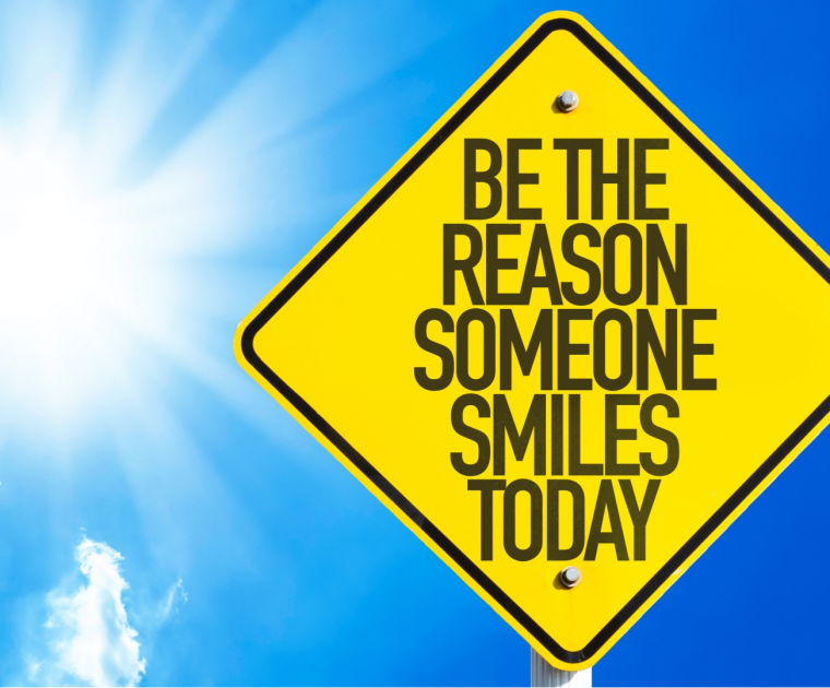 An Autralian style diamond shaped yellow roadsign bearing the wording "Be the reason someone smiles today"