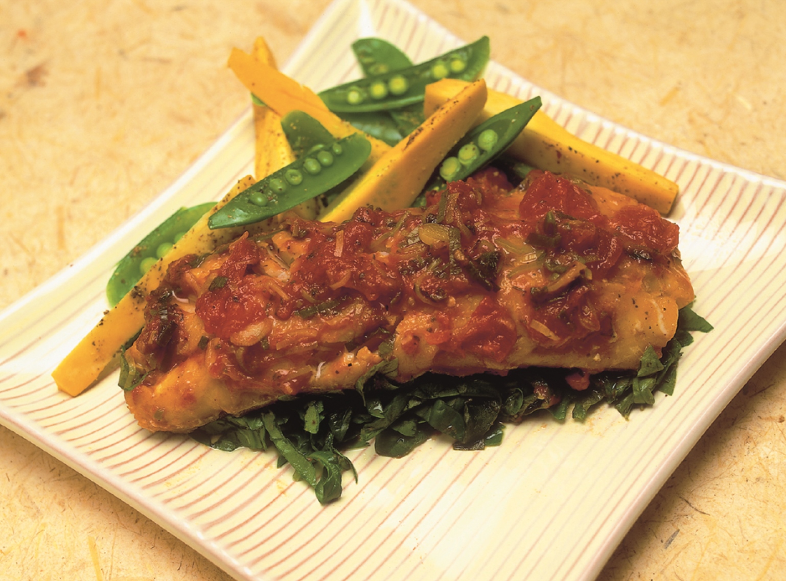 a square dish of Baked Smoked Haddock with assorted vegetables