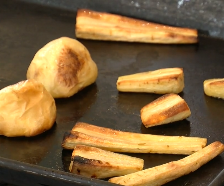 Roasted parsnips and potatoes on a baking tray