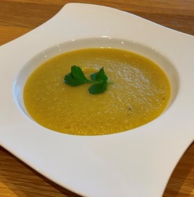 Curried Parsnip soup in a white bowl