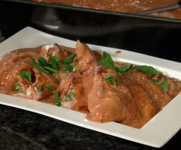 Creamy, oven-baked Chicken Tikka Masala on a white rectangular dish