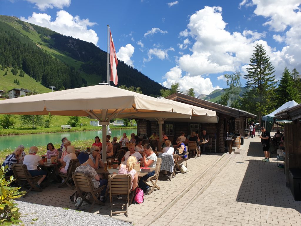 Austrian Activity Holiday group having lunch on the terrace beside the fishing lake