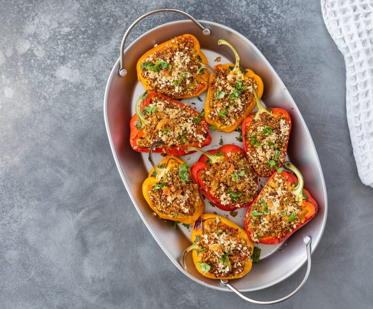 Red and yellow peppers halved and stuffed with tomatoes, sardines and garlic