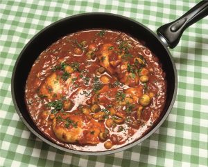 Chicken Winter Casserole, Chicken in a tomato, red wine and herb sauce in a frying pan