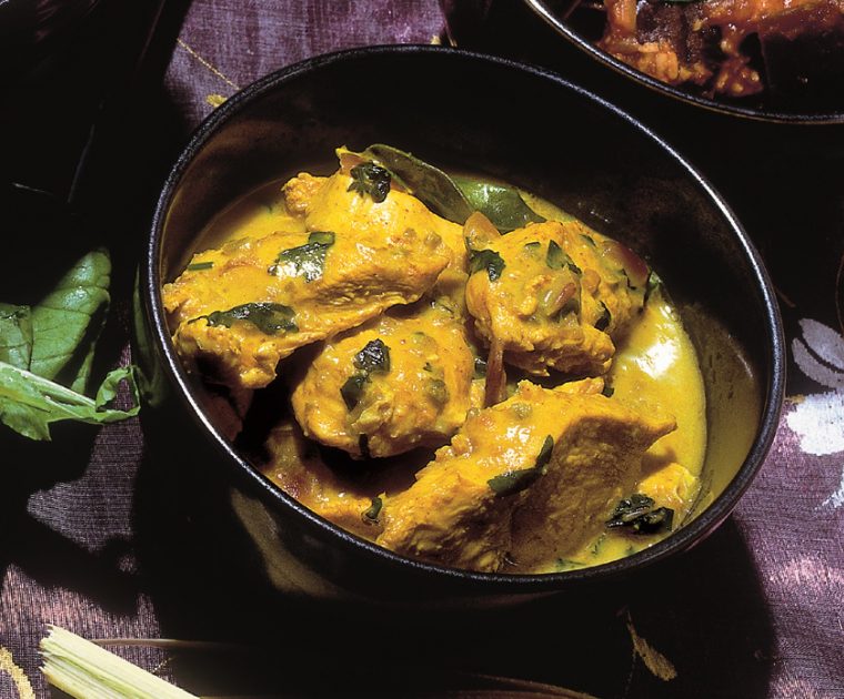 Thai Green Curry in a round black cooking pot