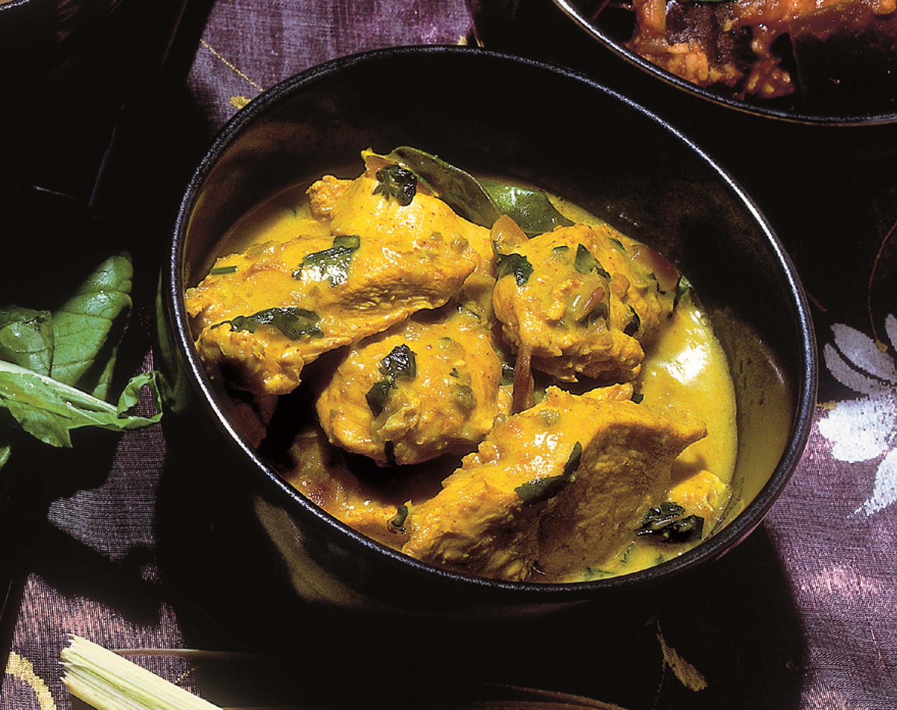 Thai Green Curry in a round black cooking pot
