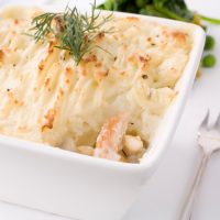 Smoked haddock fish pie topped with mashed potato and garnished with dill