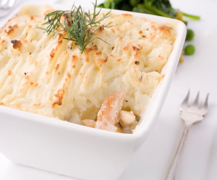 Smoked haddock fish pie topped with mashed potato and garnished with dill