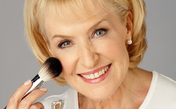 Rosemary Conley applying make up to her face with a cosmetic brush