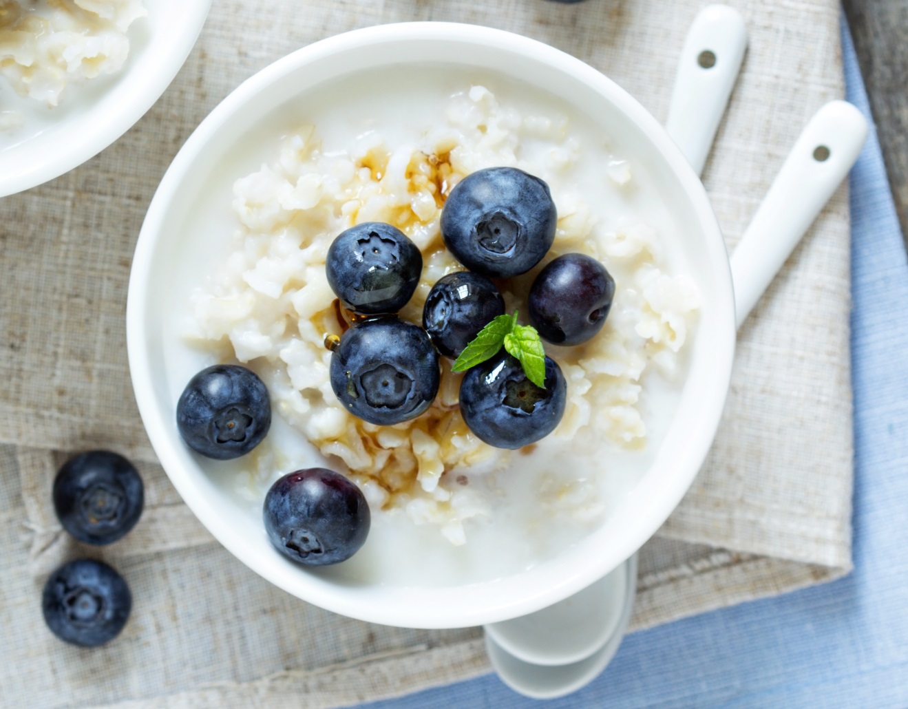 A bowl of rice pudding topped with blueberries